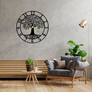Puede incluir: Reloj de pared de metal negro con un diseño de árbol de la vida. El reloj tiene manecillas doradas y números romanos. El reloj está colgado en una pared gris en un salón.
