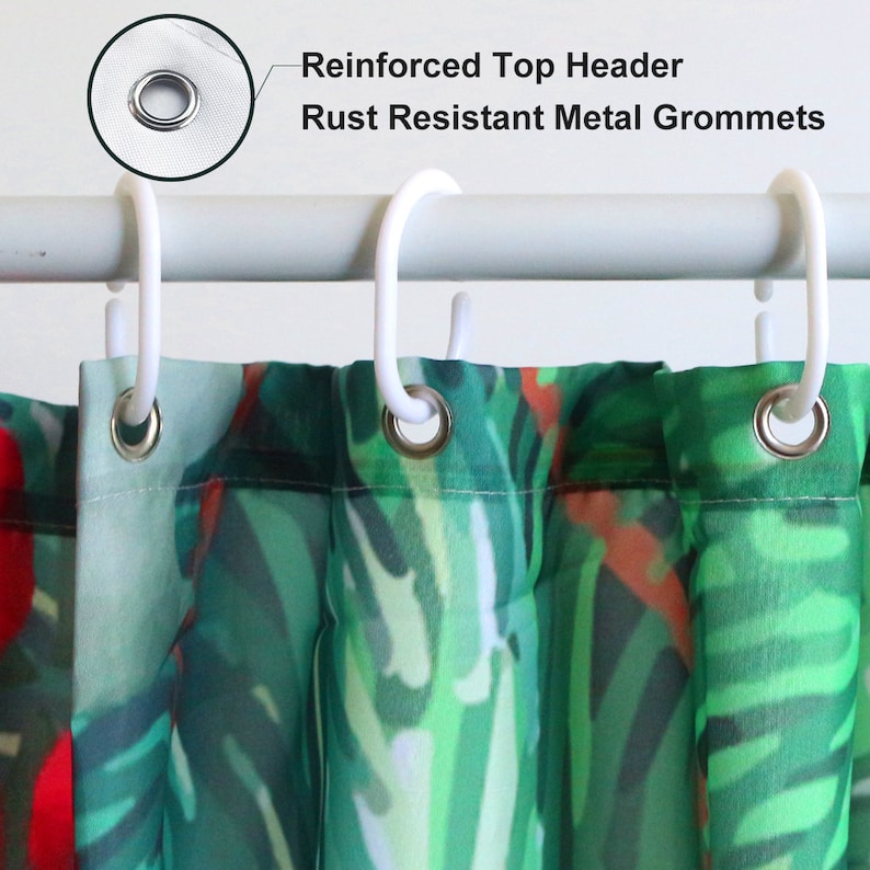 May include: Close-up of a shower curtain with a tropical leaf pattern in shades of green and red. The curtain has a reinforced top header and rust resistant metal grommets.