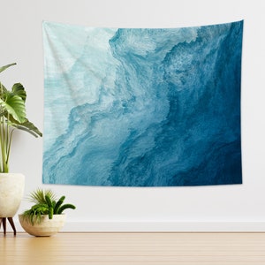 May include: A large wall tapestry with an abstract design in shades of blue. The artwork features a flowing, textured pattern reminiscent of water or waves. The color palette ranges from light turquoise to deep navy, creating a sense of depth and movement.