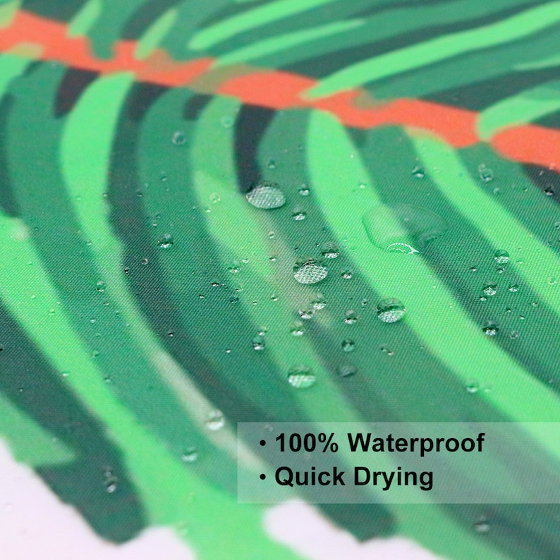 May include: Close-up of a green and orange tropical leaf patterned fabric shower curtain. Water droplets are on the fabric, demonstrating its waterproof and quick-drying features.