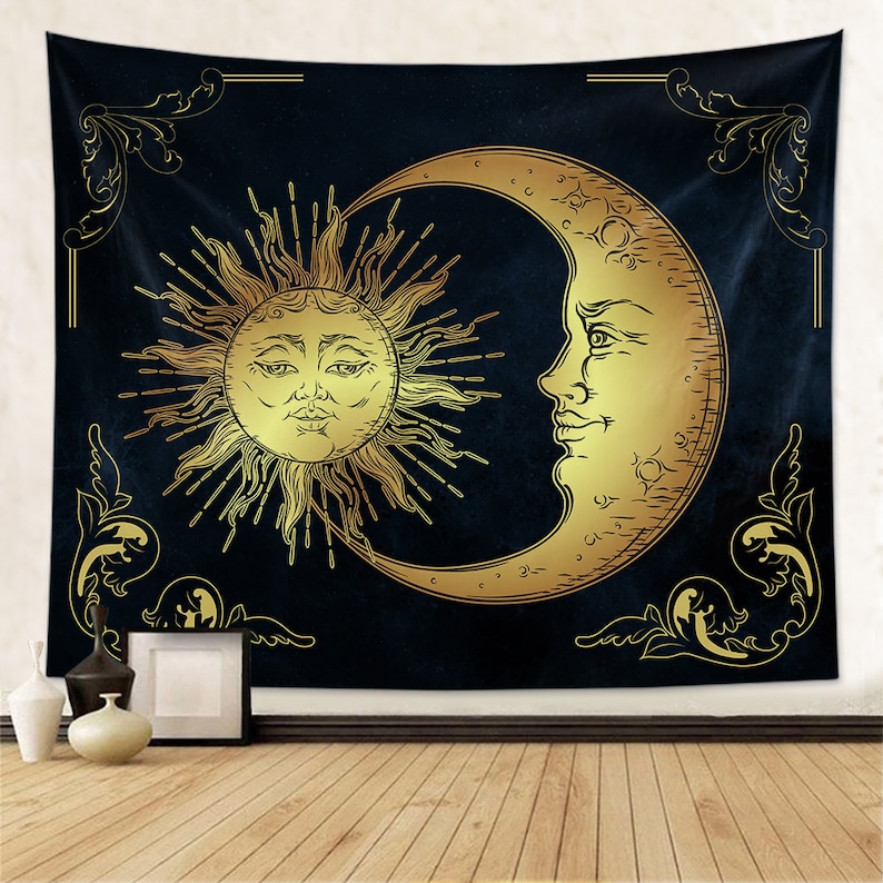 May include: A tapestry featuring a gold sun and crescent moon on a dark blue background. The sun and moon have faces and are surrounded by ornate gold scrollwork.