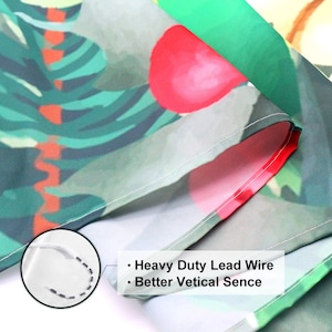 May include: Close-up of a green, red, and white fabric with a tropical leaf pattern. The fabric has a white seam along the edge and a white lead wire sewn into the seam. The text "Heavy Duty Lead Wire" and "Better Vertical Sence" is visible on the fabric.