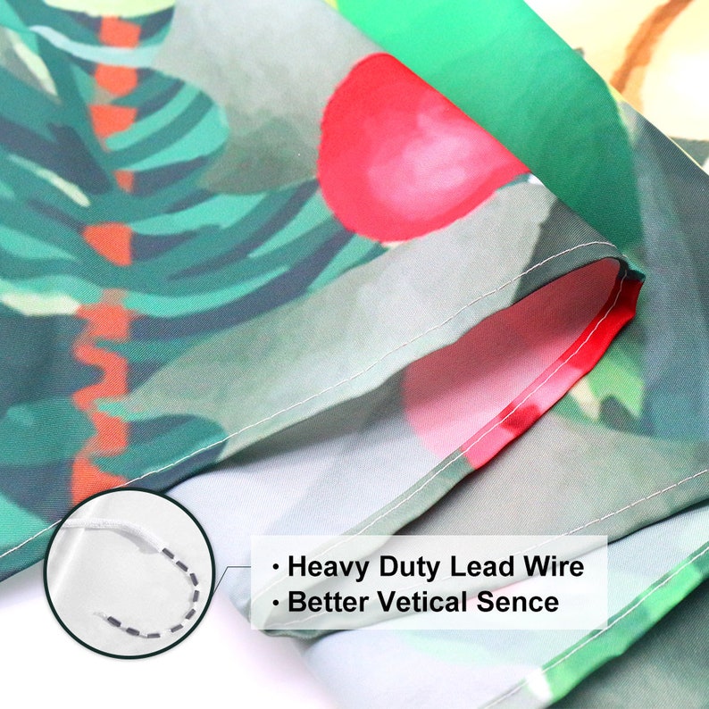 May include: Close-up of a green, red, and white fabric with a tropical leaf pattern. The fabric has a white seam along the edge and a white lead wire sewn into the seam. The text "Heavy Duty Lead Wire" and "Better Vertical Sence" is visible on the fabric.