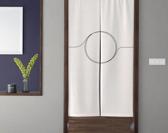 May include: White linen room divider with a black circle and line design. The divider is hanging on a wooden door frame.