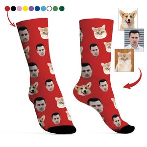 May include: Red socks with a repeating pattern of a man's face, a cat's face, and a dog's face. The socks have a black heel and toe. The socks are a novelty item.