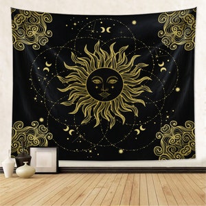 May include: A black tapestry with a gold sun and moon design. The sun has a face and is surrounded by stars and crescent moons.