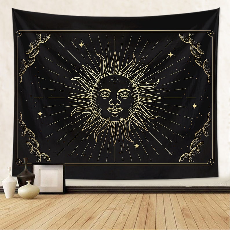 May include: Black tapestry with a gold sun with a face and rays emanating from it. The sun is surrounded by stars and clouds.