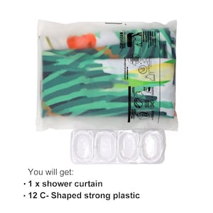 May include: A clear plastic bag containing a shower curtain with a tropical leaf pattern. The bag also includes a label with washing instructions.  A clear plastic tray with 12 C-shaped compartments is also shown. The text "You will get: 1 x shower curtain 12 C-Shaped strong plastic" is visible below the tray.