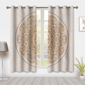 May include: A pair of beige curtains with a large brown mandala design printed on each panel. The curtains have eyelets at the top for hanging.