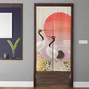 May include: A pair of white cranes with red heads stand in front of a large red sun and white chrysanthemum flowers. The background is a light pink and purple gradient with white clouds.