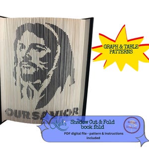 May include: A black and white book fold art project featuring a portrait of Jesus Christ. The title "OUR SAVIOR" is printed at the bottom of the image. The image includes the text "Shadow Cut & Fold book fold" and "PDF digital file - pattern & instructions included".