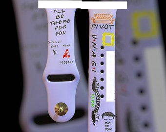 May include: A purple silicone watch band with a white design featuring the text "I'll be there for you", "Pivot", "V-N-A-G-I", "236 Central Perk", and "How you doin?" along with images of a cat, lobster, couch, and a picture frame.