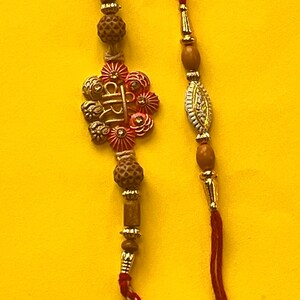 A Pair of Beautiful Veera Rakhi and Beaded Rakhi for your Brother with Complimentary Kumkum Chawal and handwritten Rakshabandhan Card