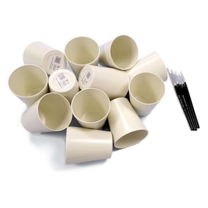 May include: A set of ten off-white ceramic paint pots with a set of six black and white paint brushes.