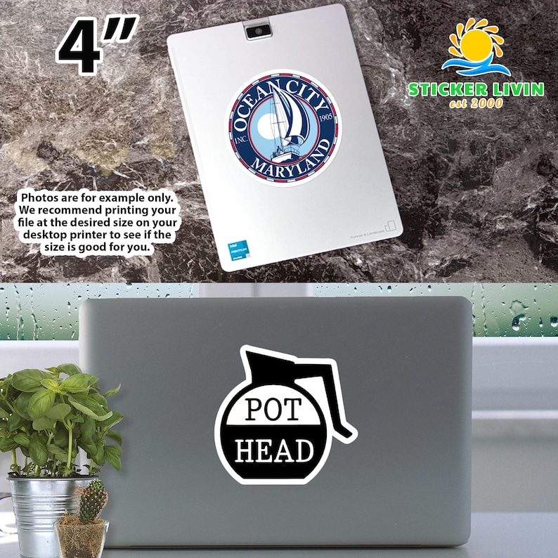 May include: A white sticker with a black graphic of a coffee pot silhouette and the text POT HEAD in black letters, applied to a gray laptop. A second sticker featuring an Ocean City Maryland sailboat logo is visible on a white tablet above.