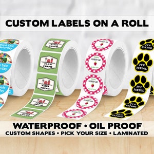 May include: Rolls of custom labels with various designs. One roll features "Book Sale Saturday" labels, another displays "Farm Fresh" labels with a farm scene, and a third showcases "Raspberry Jam" labels. The last roll has "Pup Patrol" labels. The text "Custom Labels on a Roll" is at the top.