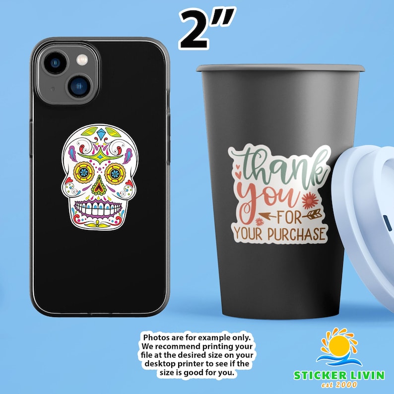 May include: A black smartphone case featuring a colorful sugar skull sticker and a black tumbler with a sticker that reads thank you for your purchase. The text 2 inches is displayed at the top, indicating the size of the stickers shown.