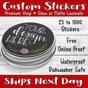 May include: A stack of round custom stickers with a chalkboard design. The stickers feature the text "YOUR design HERE" in white script, with a pink flower and green leaves. Additional text includes "Premium Vinyl" and "Waterproof".