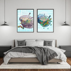 May include: Two framed prints of colorful cereal in a bowl with a spoon. The prints have a blue and white background with a pattern of lines. The text "Made with Love" is visible on one of the prints.