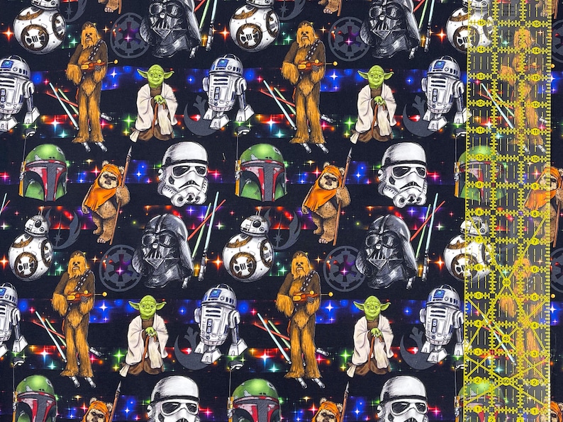 May include: Dark blue fabric patterned with Star Wars characters including Darth Vader, Yoda, Chewbacca, and R2-D2. The design also features helmets, lightsabers, and a starry background.