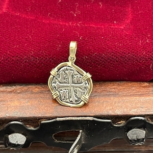 Atocha shipwreck treasure Mel fisher silver coin pendant in 14k gold bezel Made from atocha silver bars and it comes with the certificate