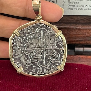 Heavy Atocha shipwreck treasure Mel fisher silver coin pendant in solid 14k gold strong gold bezel and bale. Comes with the certificate.