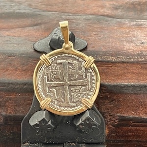 Atocha Shipwreck Treasure Mel fisher silver coin pendant in 14k solid gold bezel and solid strong prongs. Coin is made from atocha silver.