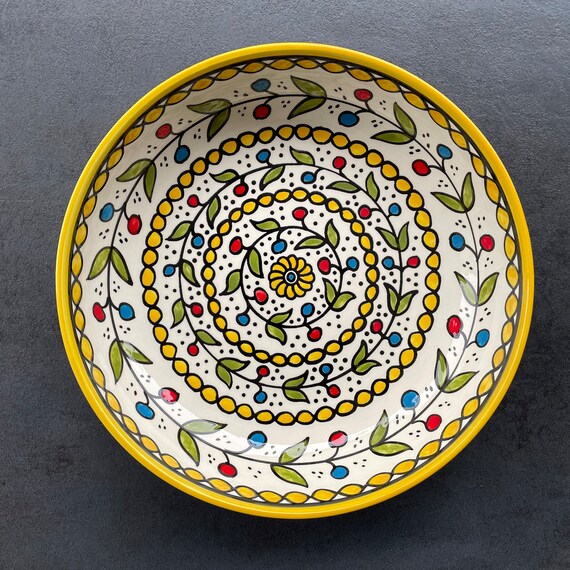 Yellow fruit bowl with oriental floral details, salad bowl, eating utensils, table decoration, boho