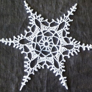 May include: A white crocheted snowflake with a six-pointed star shape and intricate details.