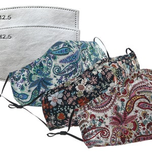 May include: Face masks with adjustable ear loops and various floral and paisley patterns in blue, black, and red. Two PM2.5 filters are also included. The masks are made of fabric and have black elastic straps.
