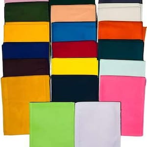 May include: A collection of rectangular fabric swatches arranged in a grid, featuring a diverse palette of solid colours including pink, dark green, navy, peach, blue, red, yellow, orange, teal, light blue, lime green, and white.
