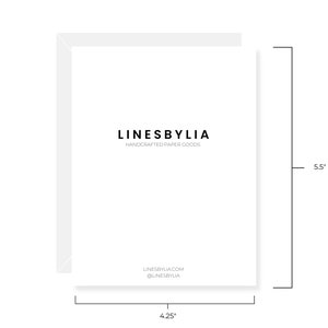 May include: A white card with the text "LINESBYLIA" in black, centered on the card. Below the text is "HANDCRAFTED PAPER GOODS" in smaller black text. The bottom of the card has the text "LINESBYLIA.COM @LINESBYLIA" in black. The card is 5.5 inches tall and 4.25 inches wide.
