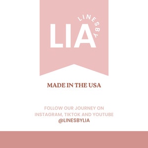 May include: A pink banner with the text "LINESBYLIA" and the word "LIA" in white. The banner has a pointed bottom and the text "MADE IN THE USA" is below the banner. The text "FOLLOW OUR JOURNEY ON INSTAGRAM, TIKTOK AND YOUTUBE @LINESBYLIA" is below the banner.