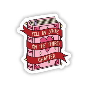 May include: A pink book sticker with a red ribbon and a heart. The text on the sticker reads "Fell in love on the third chapter."