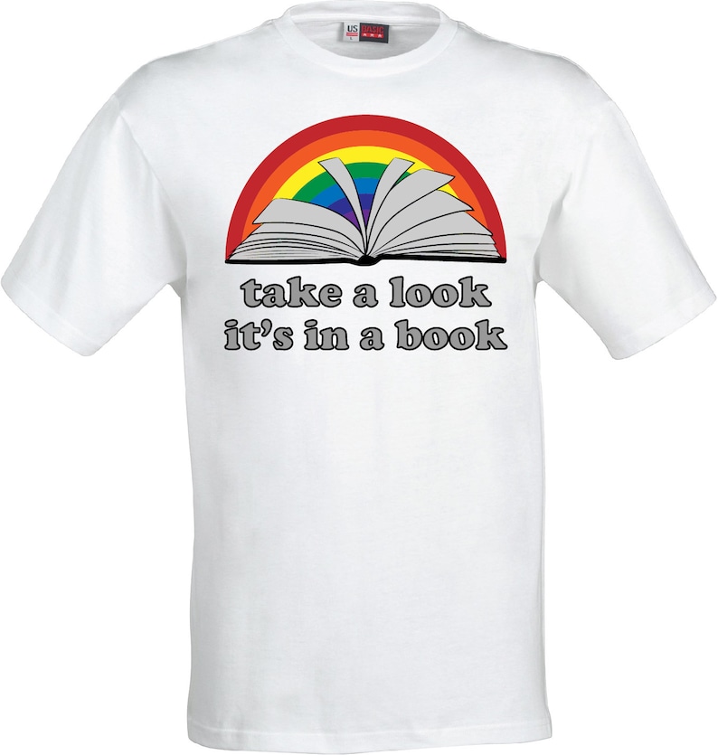 May include: White t-shirt with a rainbow arc over an open book and the text "take a look it's in a book".