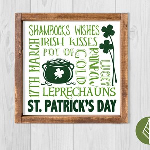 Pode incluir: Uma placa de madeira com fundo branco e texto verde. O texto diz "Shamrocks Wishes Irish Kisses Pot of Gold Rainbow Lucky Leprechauns St. Patrick's Day". Há um pote de ouro verde com um trevo no topo e um trevo com um caule.