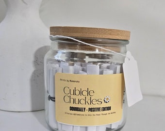 May include: A glass jar with a wooden lid filled with rolled up pieces of paper. The jar has a yellow label that reads "Cubicle Chuckles COMICALLY - POSITIVE EDITION".