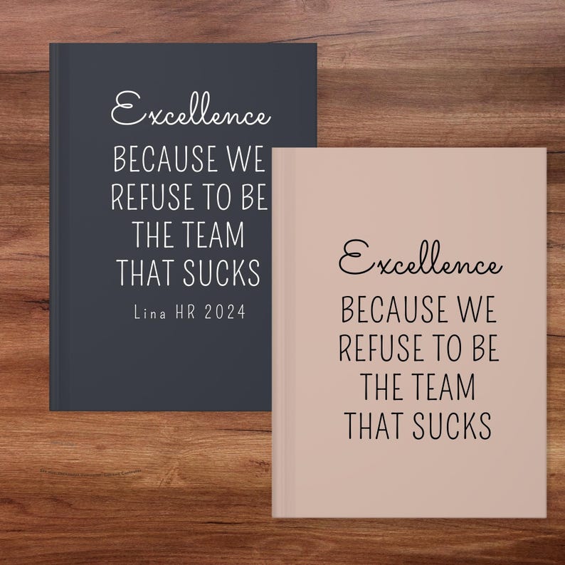 May include: Two notebooks with the text "Excellence BECAUSE WE REFUSE TO BE THE TEAM THAT SUCKS". One notebook is dark blue, the other is light pink. The dark blue notebook has "Lina HR 2024" printed on it.