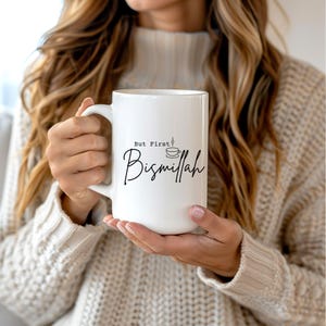 May include: White ceramic mug with a black design that says "But First, Bismillah" with a small illustration of a coffee cup with steam coming from it.