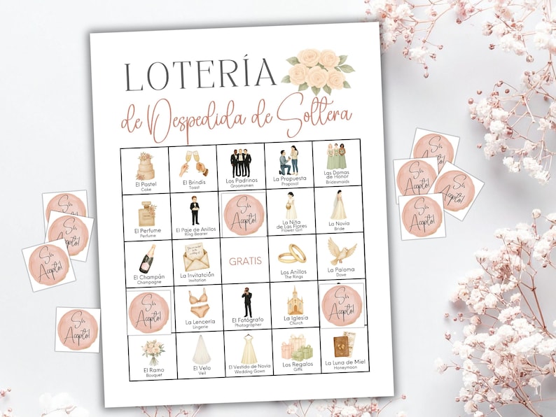 May include: A Loter&iacute;a de Despedida de Soltera game card featuring a grid of wedding-themed illustrations and text, including icons for a cake, rings, and bride. Several circular markers with the text S&iacute; Acepto are placed on the grid.