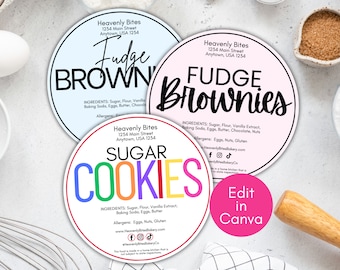 May include: Three round, white labels with colorful text and black outlines. The labels are for different types of baked goods: Fudge Brownies, Sugar Cookies, and Fudge Brownies. Each label includes the name of the bakery, Heavenly Bites, and the address. The labels are on a white background with a wooden rolling pin and a white bowl.