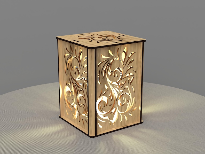 May include: A wooden lamp with a decorative floral design cut out of the sides. The lamp is lit and casting a warm glow.