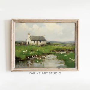 May include: A framed painting of a white cottage with a thatched roof, set against a backdrop of rolling green hills and a tranquil stream. The sky is a soft blue with fluffy white clouds.