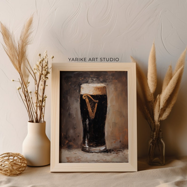 May include: A framed painting of a glass of Guinness beer with a white head and the Guinness harp logo. The painting is done in a realistic style with a brown background.