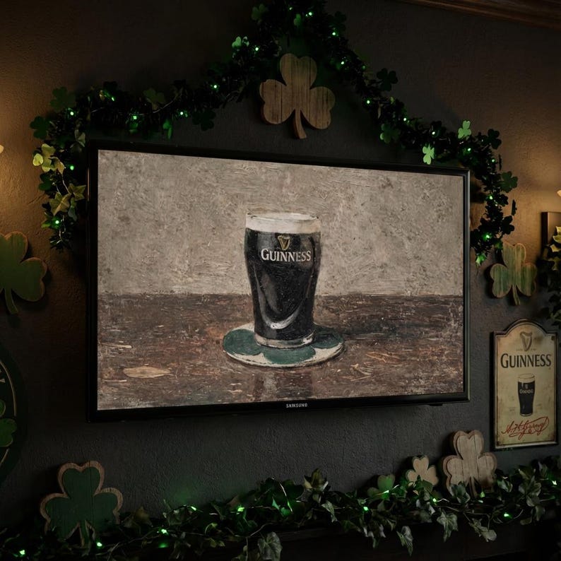 May include: A television displays a painting of a pint of Guinness stout on a coaster. The image is surrounded by St. Patrick's Day decorations, including shamrocks and green lights, creating a festive atmosphere.