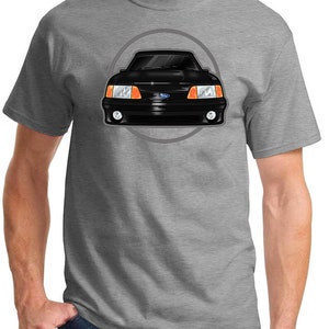 May include: A heather grey t-shirt with a black and white illustration of a Ford Mustang car in a circle.