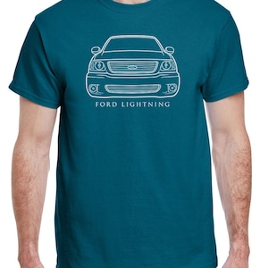 May include: A teal blue t-shirt with a white outline of a Ford Lightning truck and the text "FORD LIGHTNING" underneath.