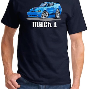 May include: A navy blue t-shirt featuring a cartoon illustration of a blue Ford Mustang Mach 1. The text "mach 1" is printed below the car.