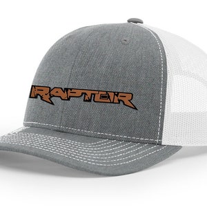 May include: A gray and white trucker hat with a brown embroidered logo that says "RAPTEIR".