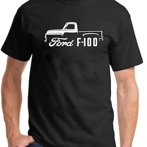 May include: Black t-shirt featuring a white graphic of a Ford F-100 pickup truck. The design includes the Ford logo and the model name. The shirt is made of a soft material and has a classic crew neck.